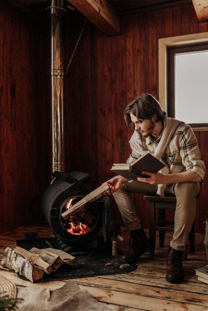 A man enjoys a quiet winter day indoors, reading by the fireplace in Moscow.